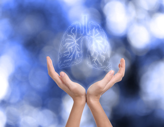 World Tuberculosis Day and No Tobacco campaign. Woman holding lungs illustration on blurred background, closeup