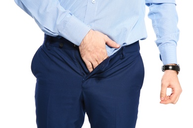 Photo of Man scratching crotch on white background, closeup. Annoying itch