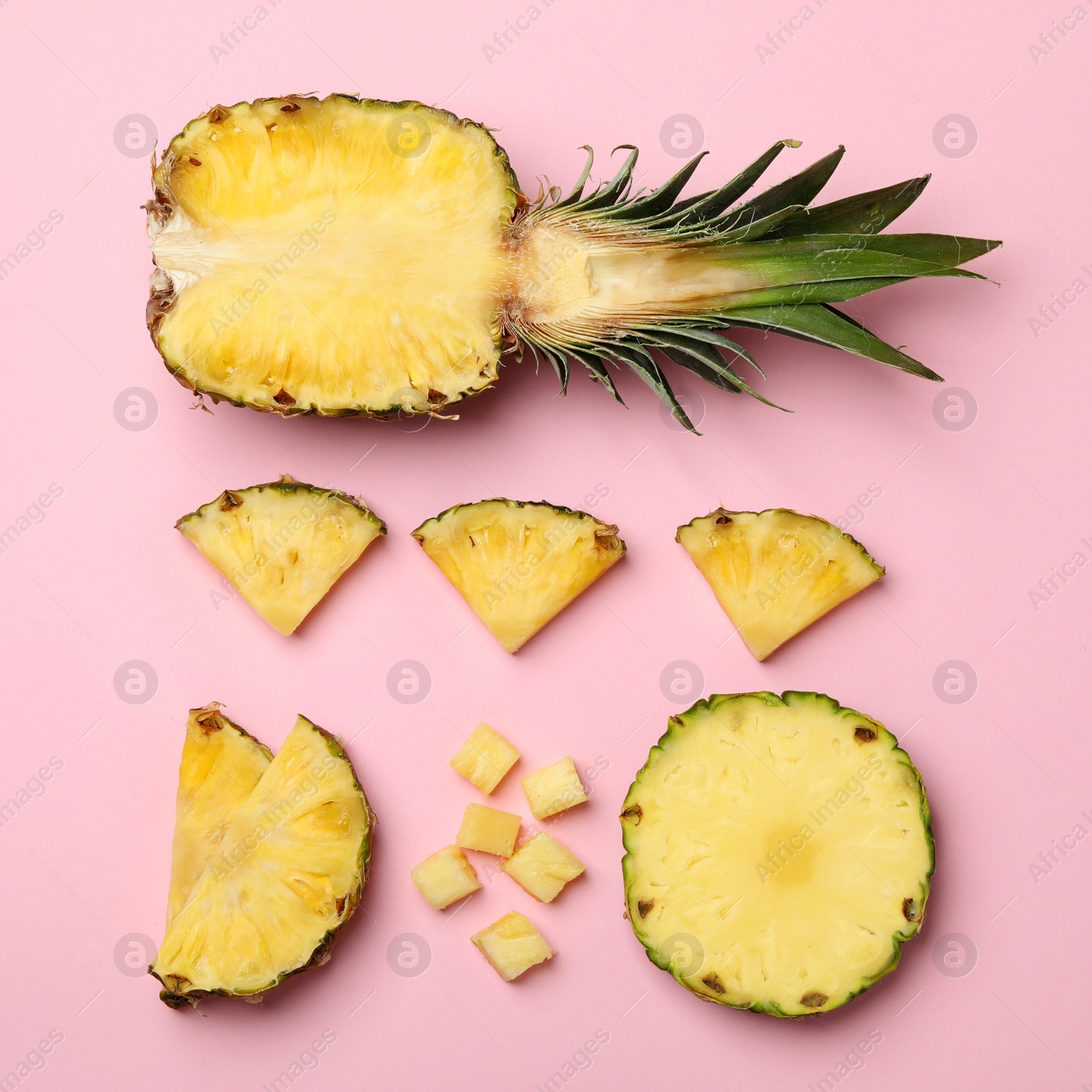 Photo of Flat lay composition with cut and fresh juicy pineapples on color background