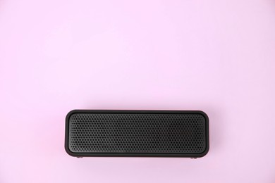 One portable bluetooth speaker on pink background, top view with space for text. Audio equipment