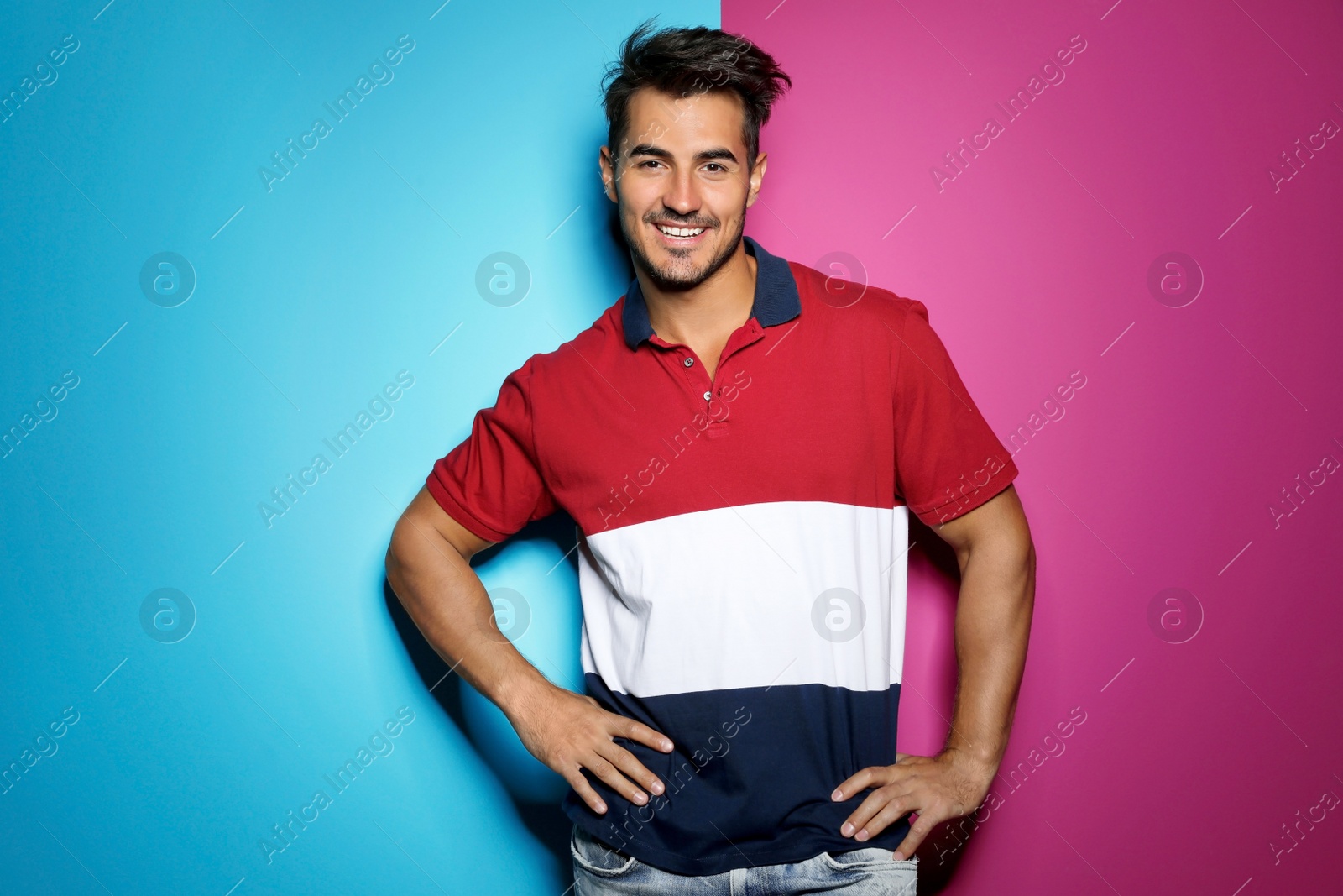 Photo of Young man with trendy hairstyle posing on color background