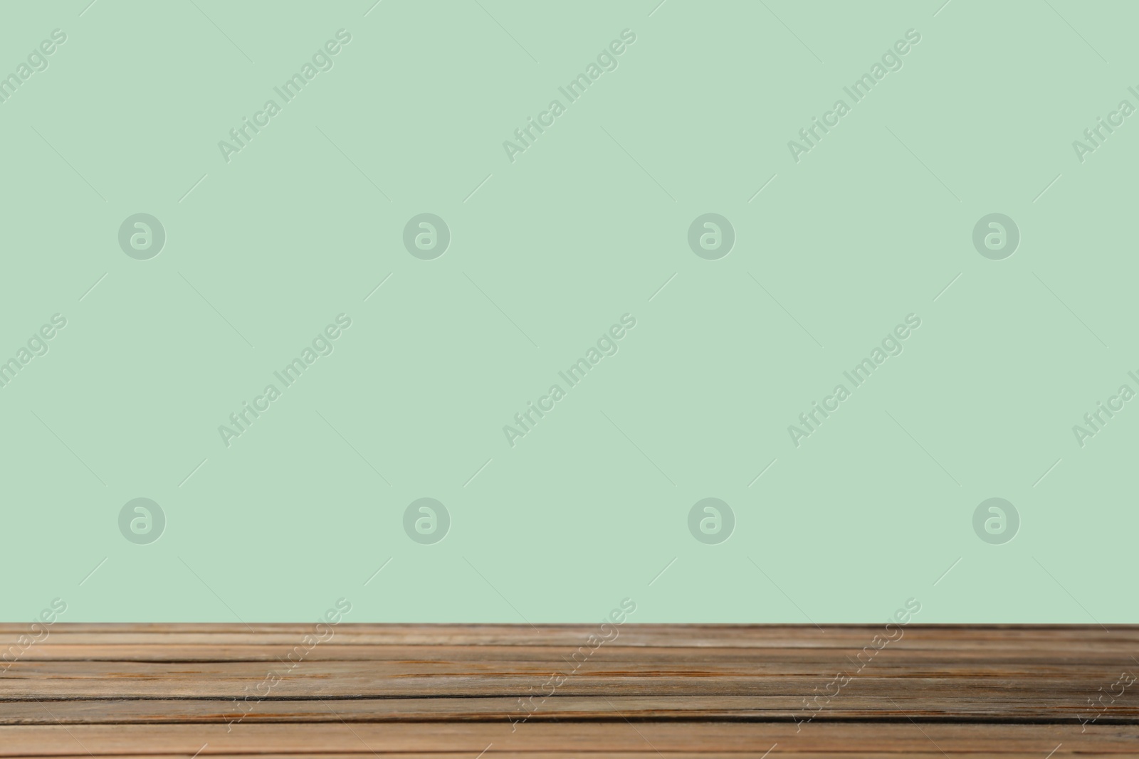 Image of Empty wooden surface on mint background. Mockup for design