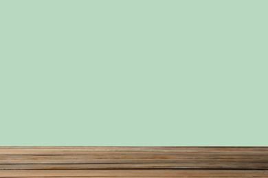 Empty wooden surface on mint background. Mockup for design