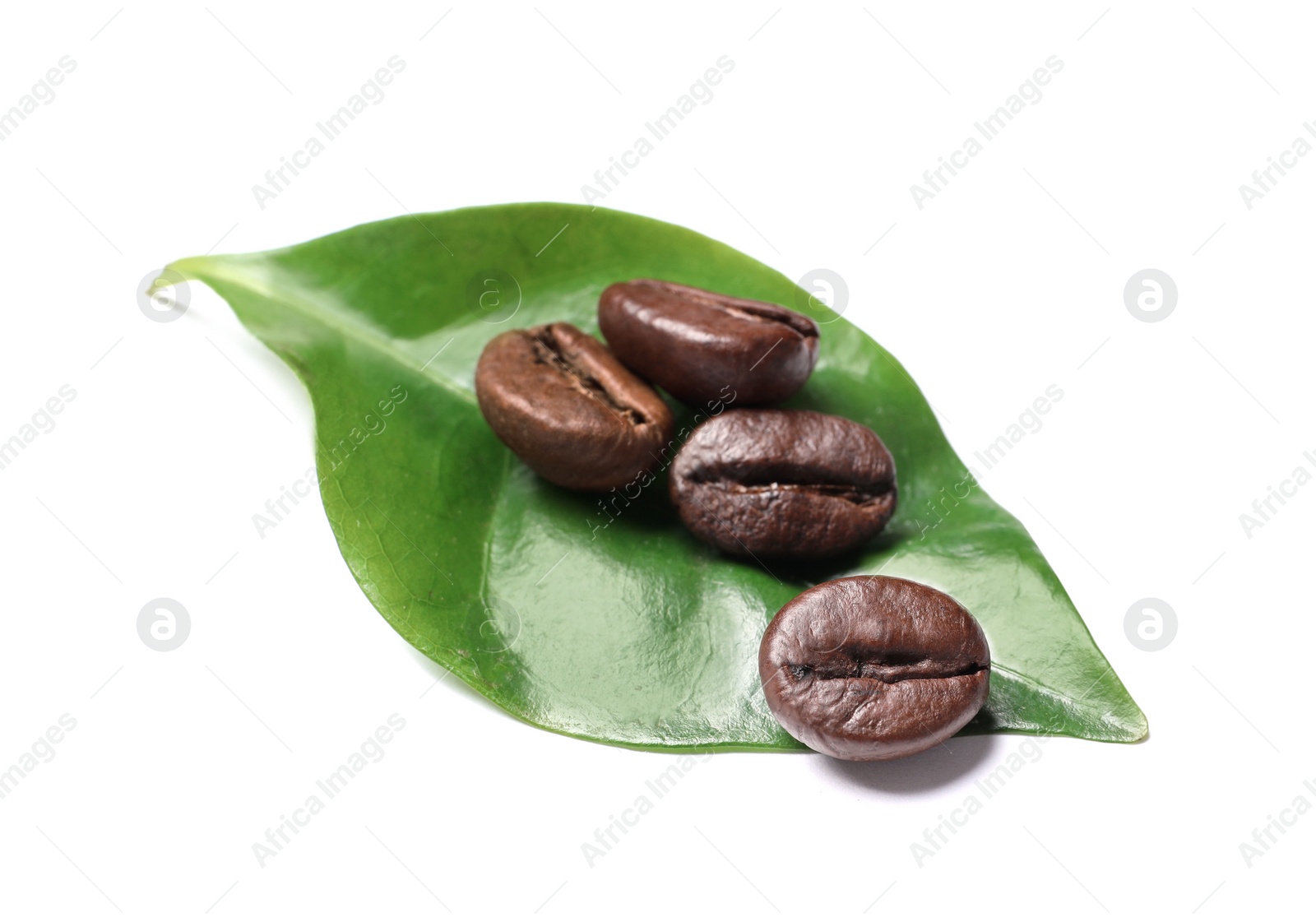 Photo of Roasted coffee beans and green leaf on white background