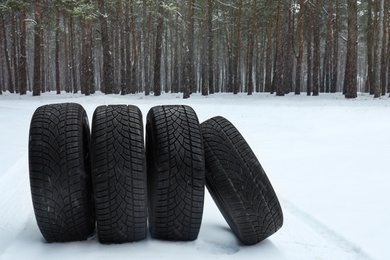 New winter tires on fresh snow near forest
