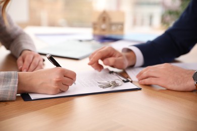 Photo of Real estate agent working with client in office, closeup