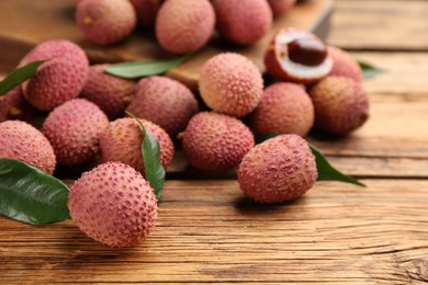 Photo of Fresh ripe lychee fruits on wooden table