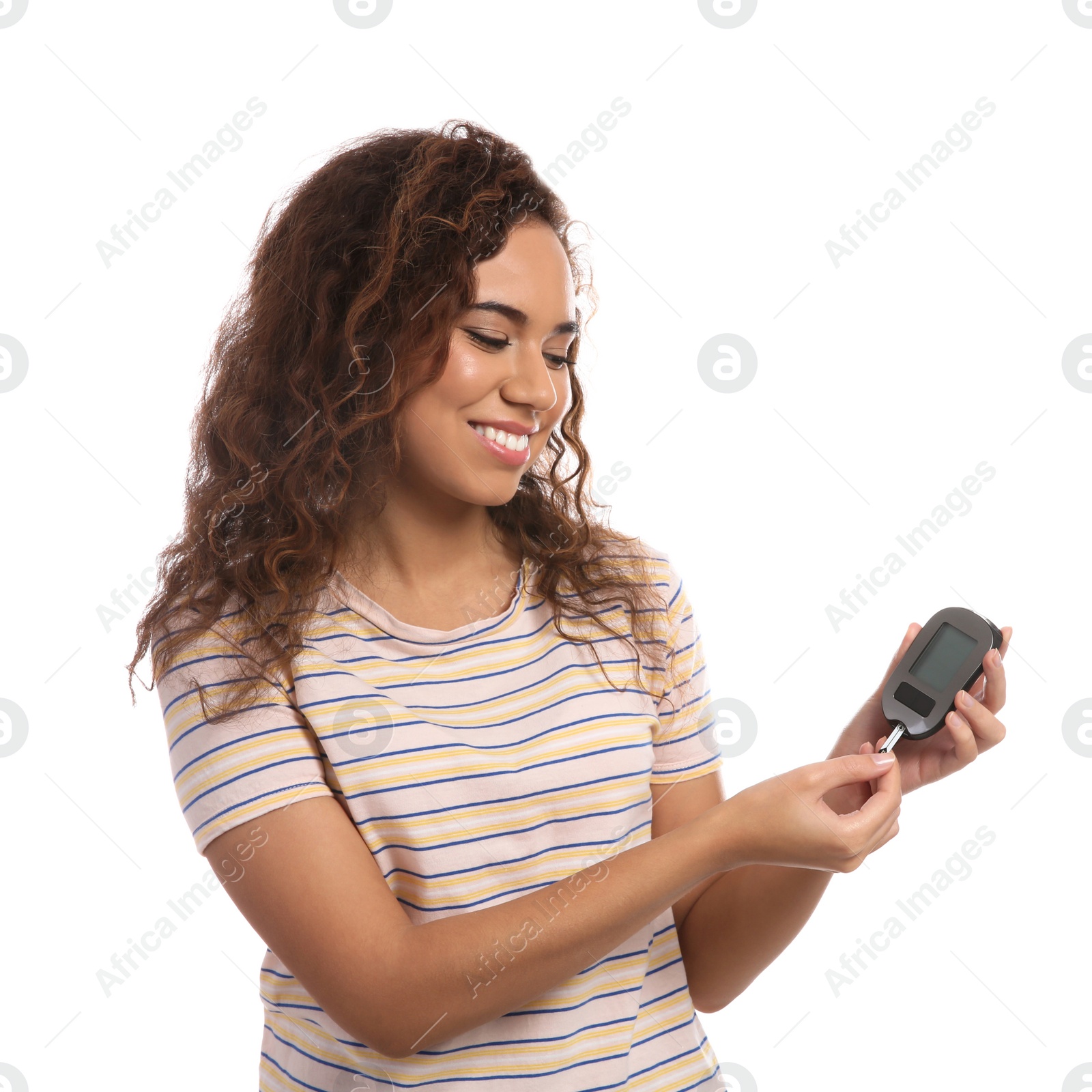 Photo of Young African-American woman holding glucometer on white background. Diabetes control