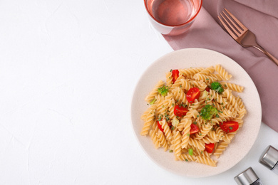 Flat lay composition with tasty pasta on white table, space for text