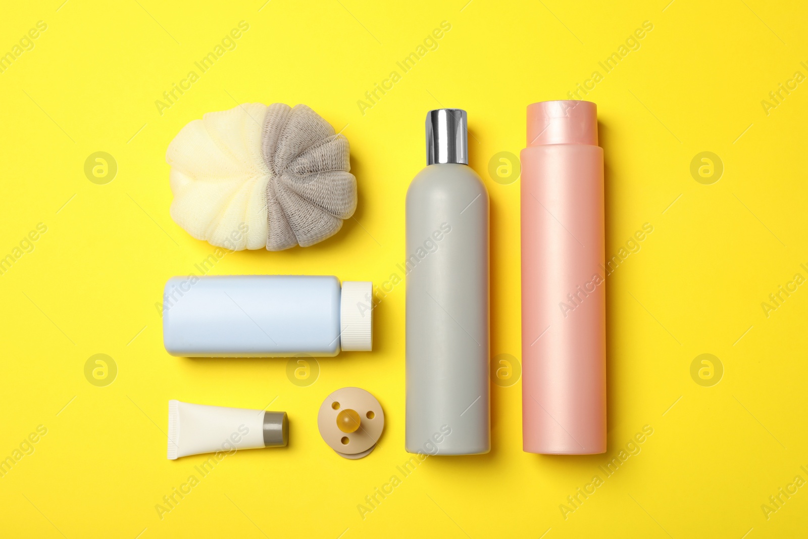 Photo of Flat lay composition with baby cosmetic products on yellow background