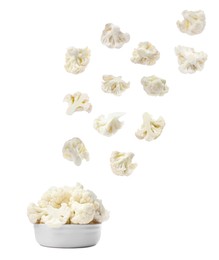 Image of Many fresh cauliflower florets falling into bowl on white background