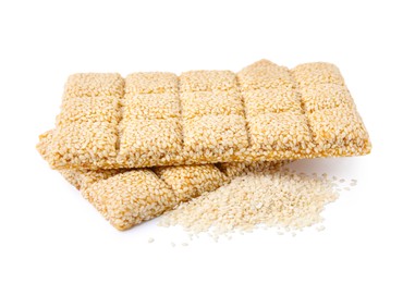 Photo of Delicious sweet kozinaki bars and sesame seeds on white background