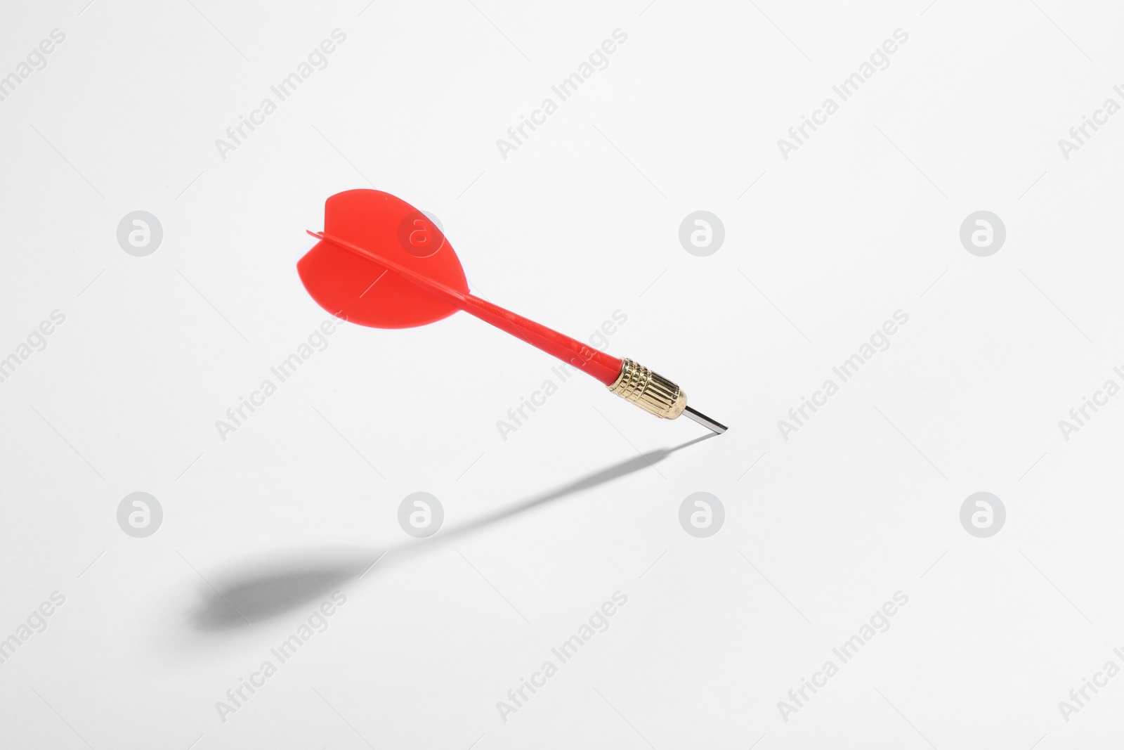 Photo of Red dart arrow for game on white background