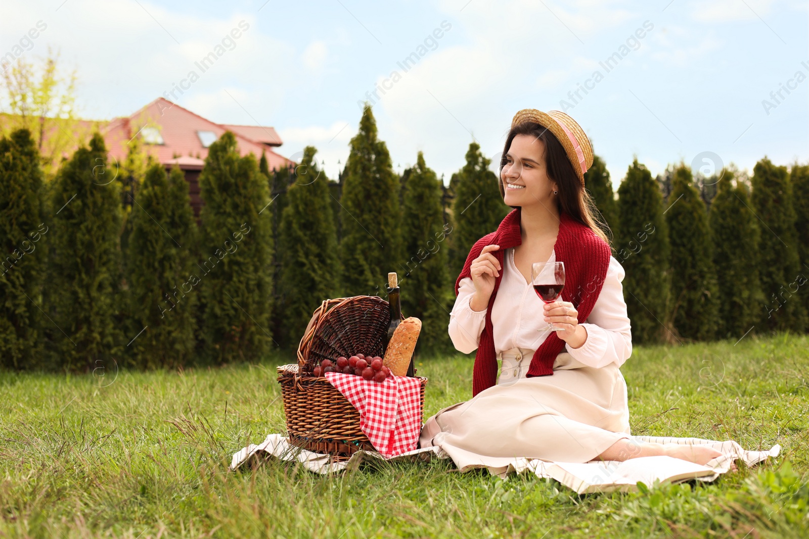 Photo of Happy woman having picnic in green park