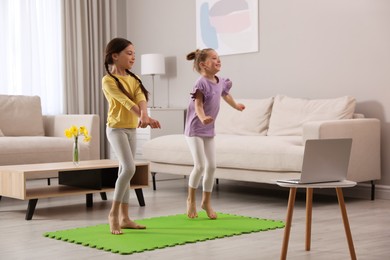 Photo of Cute little girls taking online dance class at home