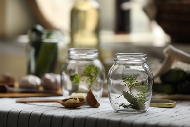Empty glass jars and ingredients prepared for canning on table. Space for text