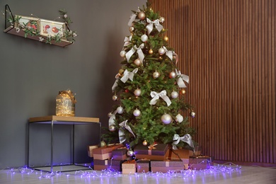 Photo of Beautiful Christmas tree and gift boxes indoors