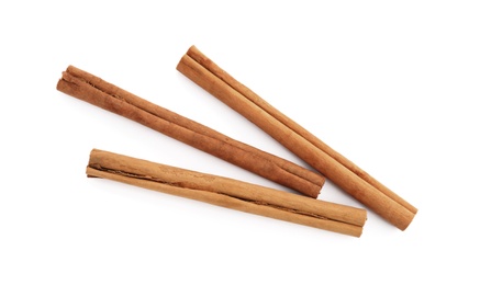 Aromatic dry cinnamon sticks on white background, top view