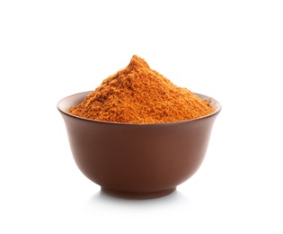 Photo of Bowl with red pepper powder on white background