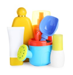 Different suntan products and plastic beach toys on white background