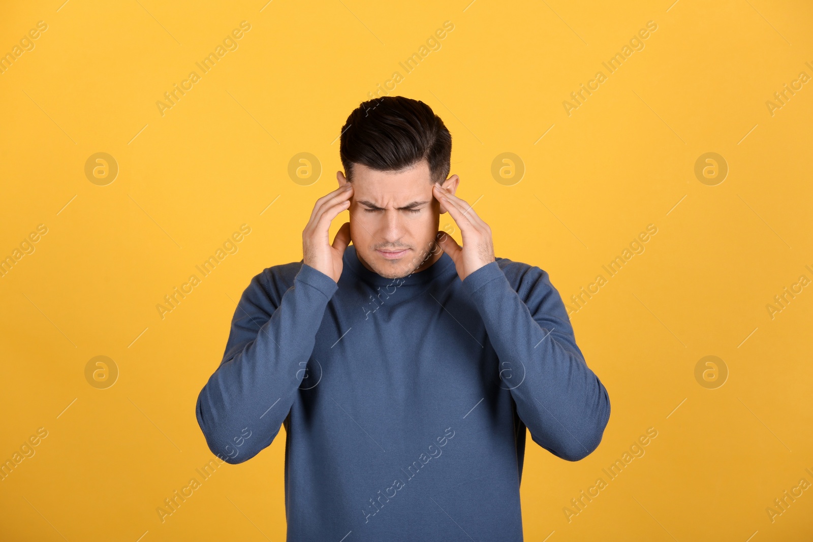 Photo of Portrait of stressed man on yellow background