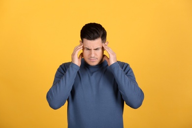 Photo of Portrait of stressed man on yellow background