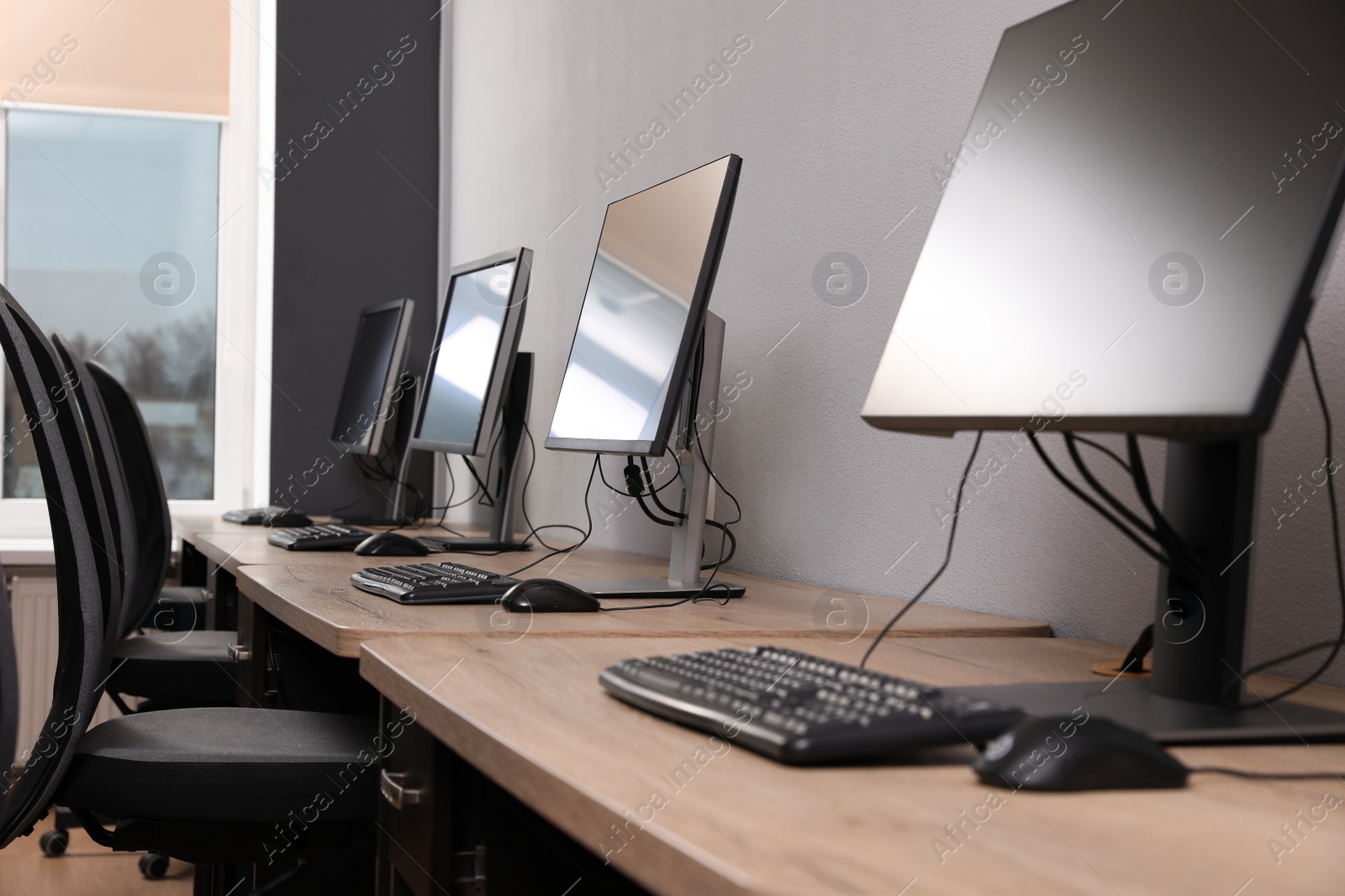 Photo of Many modern computers in open space office