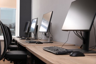 Photo of Many modern computers in open space office
