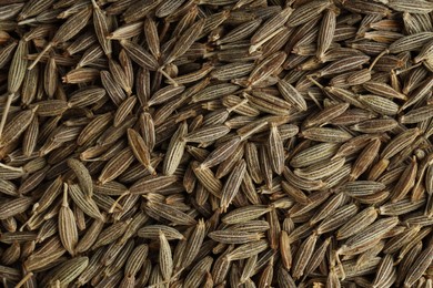 Aromatic caraway seeds as background, top view