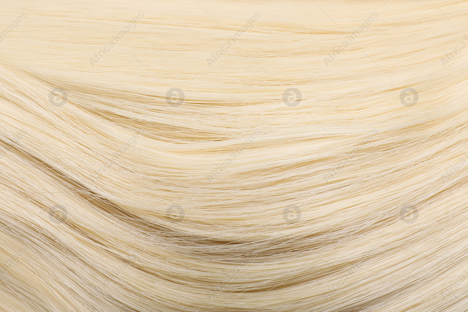 Photo of Beautiful blonde straight hair as background, closeup