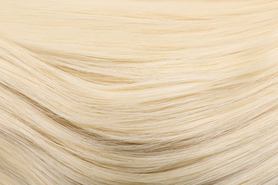 Photo of Beautiful blonde straight hair as background, closeup