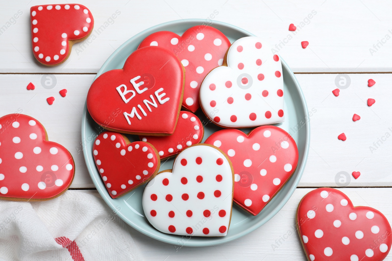 Photo of Decorated heart shaped cookies on white wooden table, flat lay. Valentine's day treat