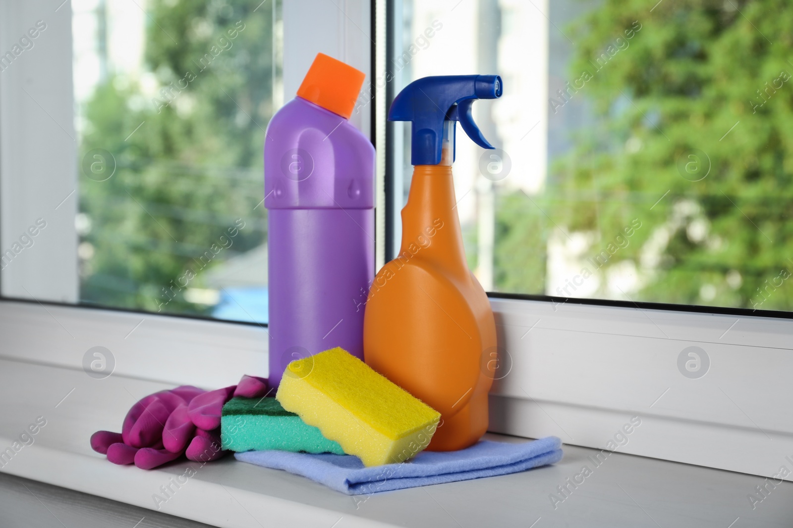 Photo of Cleaning supplies and tools on window sill indoors