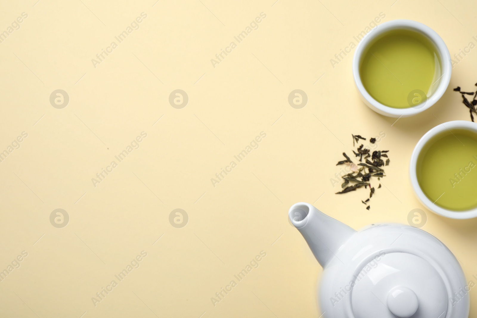 Photo of Flat lay composition with green tea on beige background. Space for text