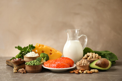 Photo of Different products rich in protein on marble table