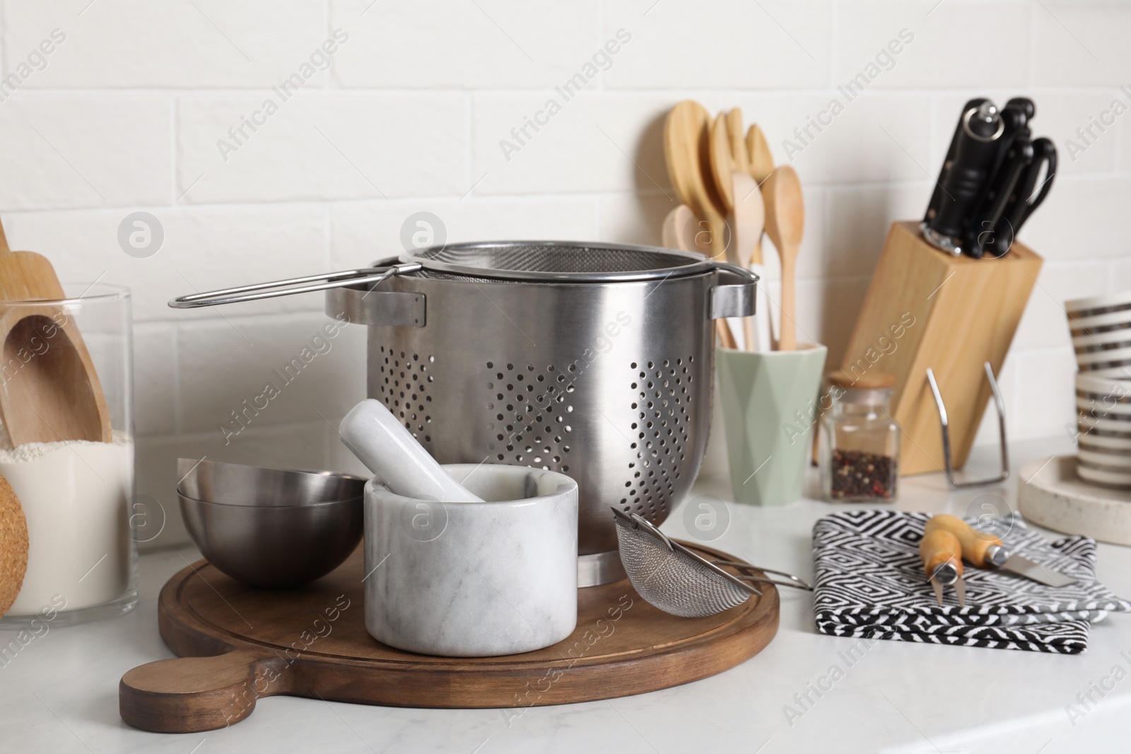 Photo of Different cooking utensils on countertop in kitchen