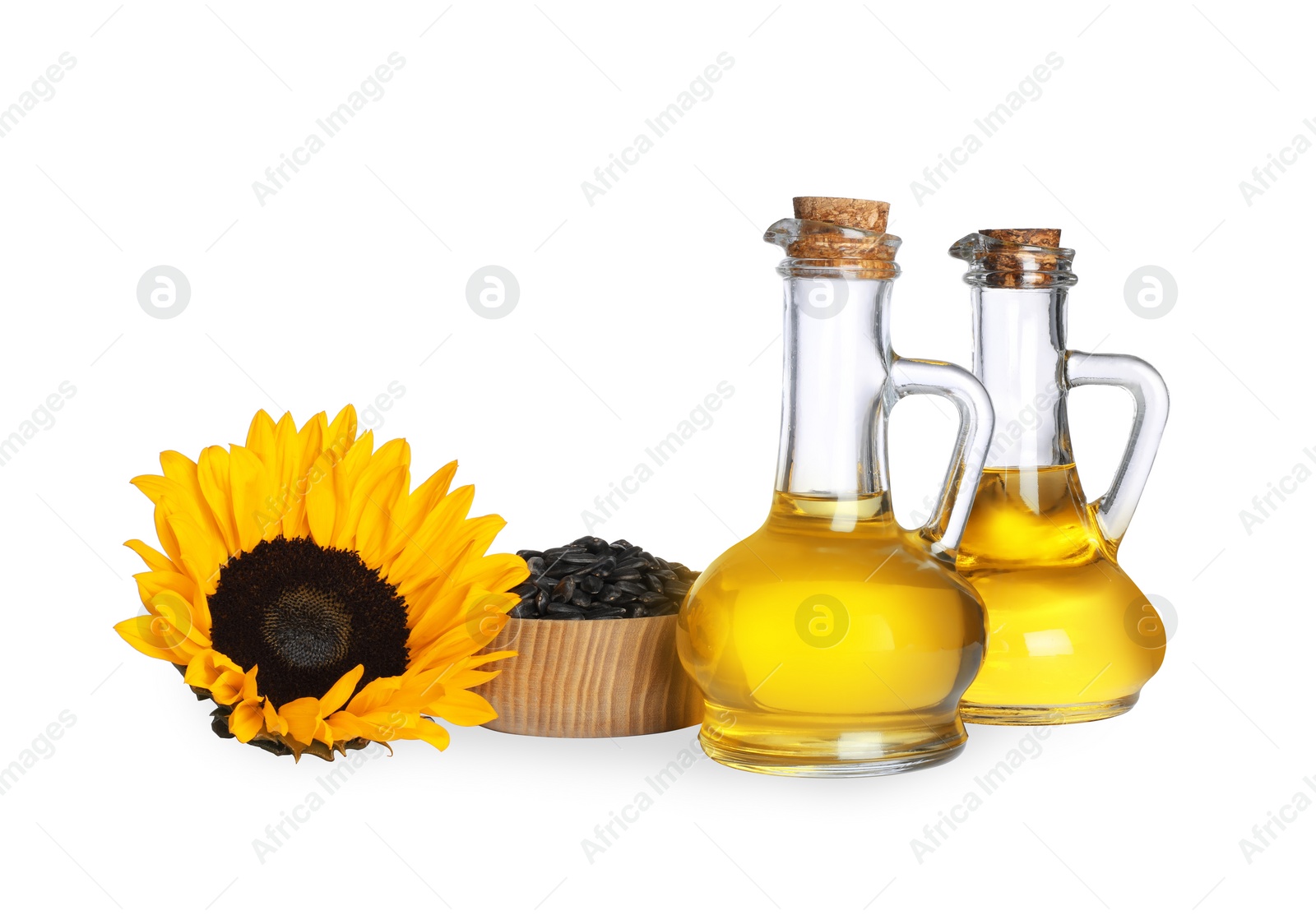 Photo of Sunflower cooking oil, seeds and yellow flowers on white background