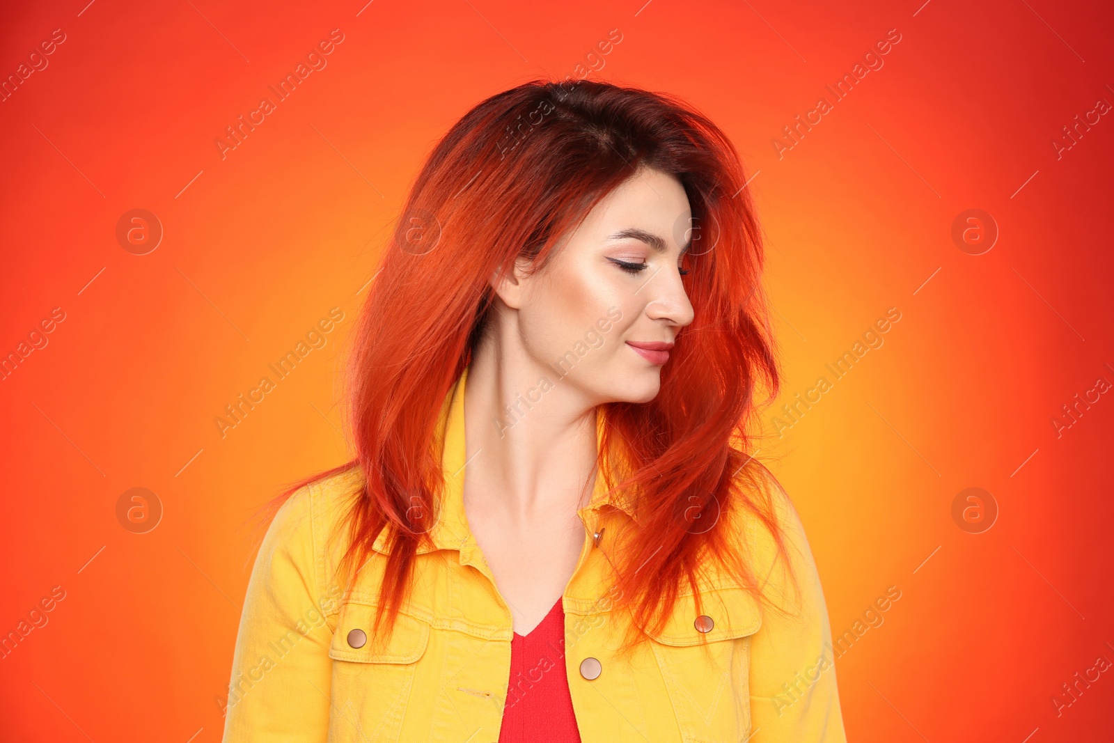 Photo of Young woman with bright dyed hair on color background