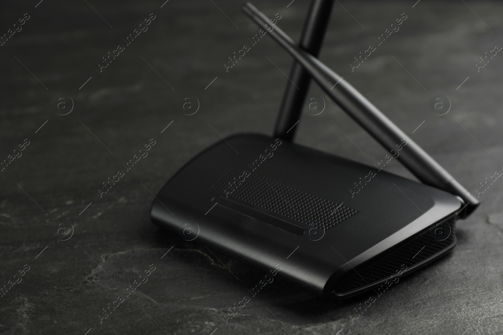 Photo of Modern wireless Wi-Fi router on black background