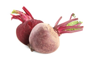 Photo of Whole and cut ripe beetroots on white background