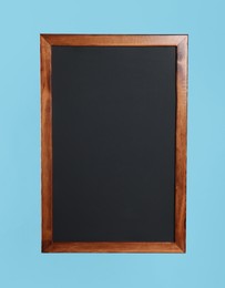Clean black chalkboard on light blue background