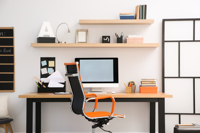 Photo of Modern computer on table in office interior. Stylish workplace