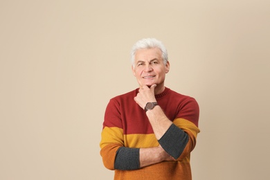 Photo of Portrait of handsome mature man on color background. Space for text