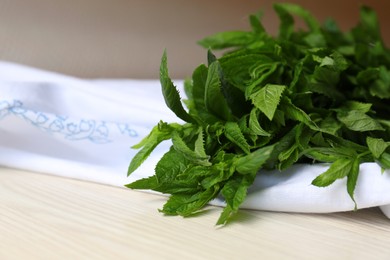 Photo of Beautiful green mint on white wooden table, closeup. Space for text