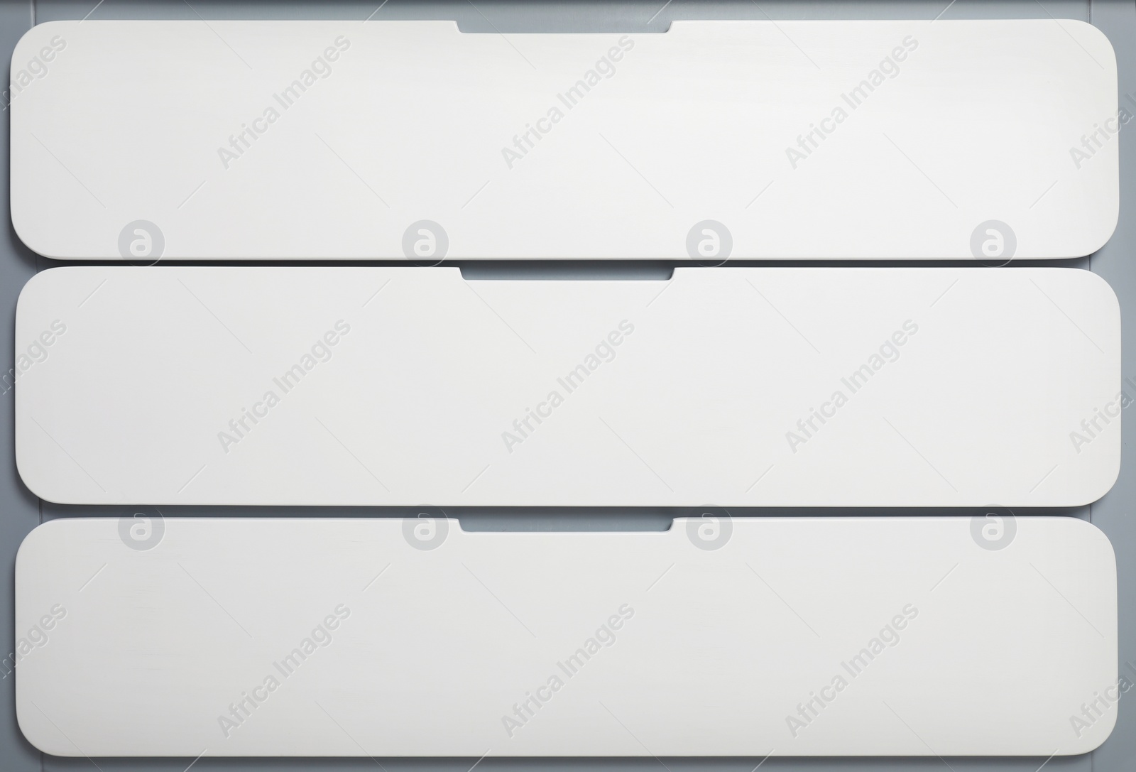 Photo of Modern white chest of drawers as background