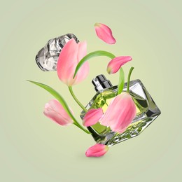 Bottle of perfume and tulips in air on olive background