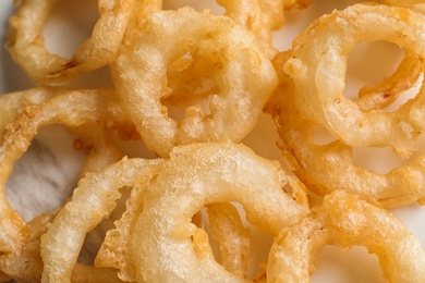 Closeup view of delicious golden breaded and deep fried crispy onion rings