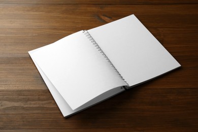 Photo of Blank paper brochure on wooden table. Mockup for design