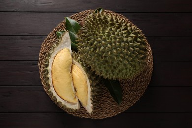 Photo of Fresh ripe durians on wooden table, top view