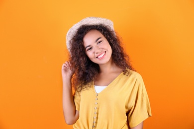 Photo of Portrait of laughing African-American woman on color background